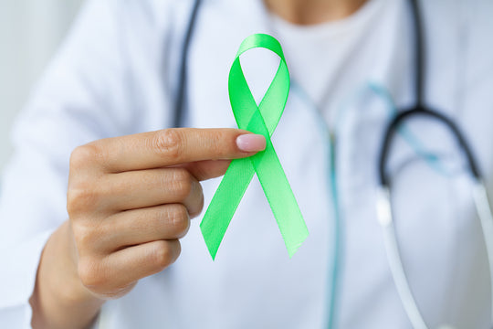 Doctor holds green ribbon as a sign of lyme disease